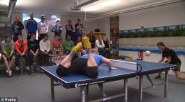 A game of headis, a mix of table tennis and football, is played in front of a small but enthusiastic gallery