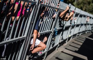 Fans wait outside the Rod Laver arena ahead of the action at the Australian Open in Melbourne